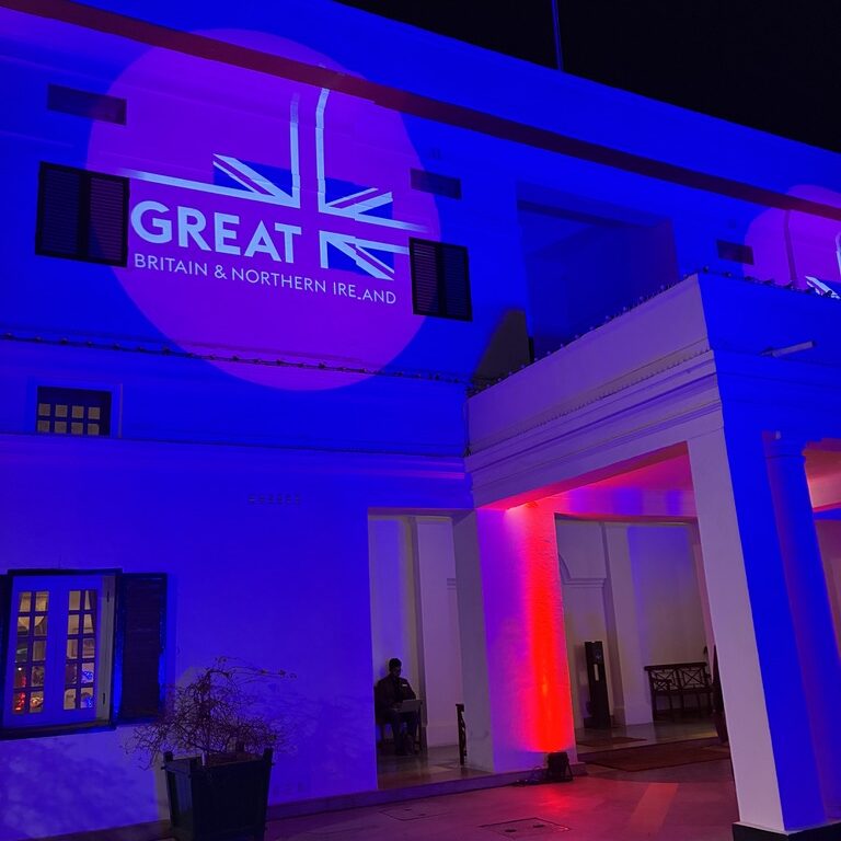 British High Commission reception venue lit in blue and red